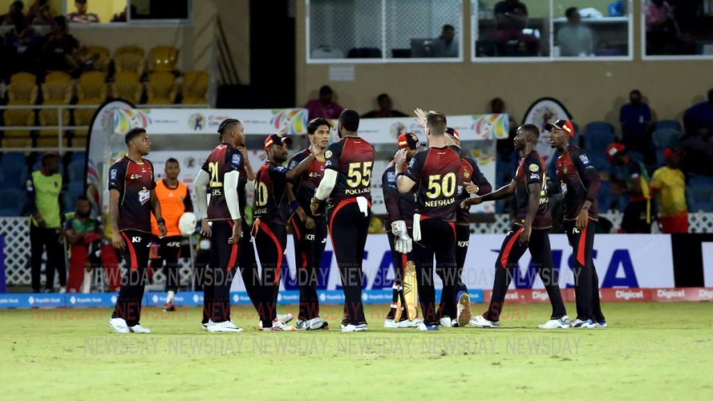 TKR players congratulate each other after winning the opening match of the 2019 Hero Caribbean Premier League against the St Kitts and Nevis Patriots, on Wednesday night, at the Queen's Park Oval, St Clair.