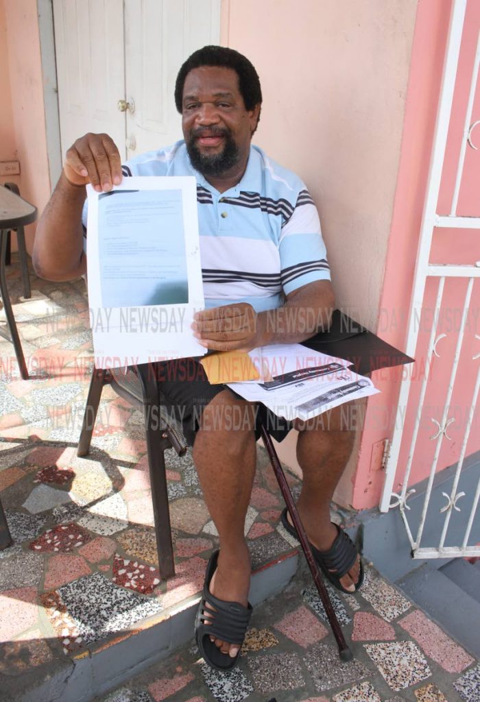 Ex-army corporal Gregory Sylvester shows a copy of his request for special allowances at his home in Arima yesterday. PHOTO  BY ANGELO MARCELLE