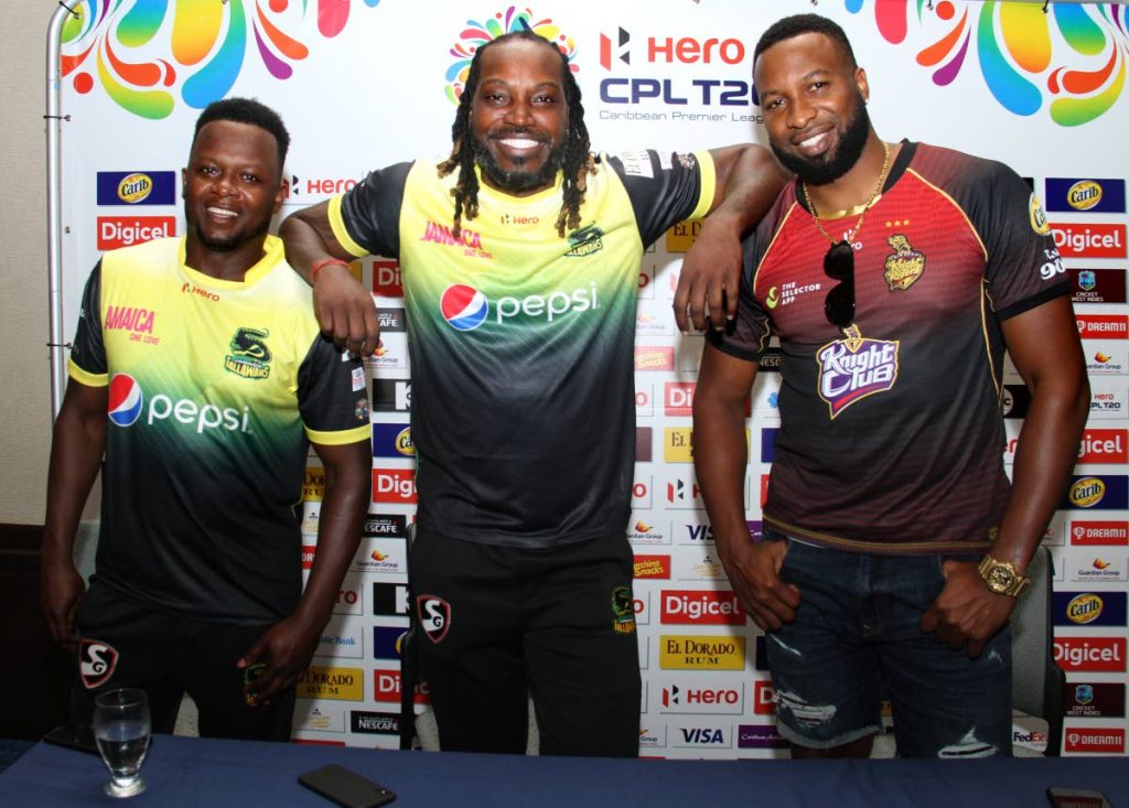 Jamaica Tallawahs’ coach Donovan Miller,left, captain Chris Gayle,centre, and Trinbago Knight Riders’ skipper Keiron Pollard are all smiles, at the Hilton Trinidad, during a pre-match press conference on the eve of their Hero CPL match tonight, at the Queen’s Park Oval, St Clai 