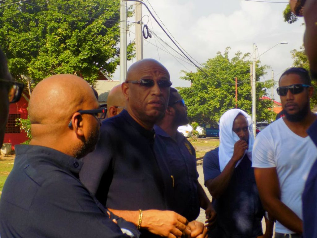 President General of the Oilfireld Workers Trade Union (OWTU) Ancel Roget, second from right, speaks to supporters outside the UTT Valsayn campus yesterday