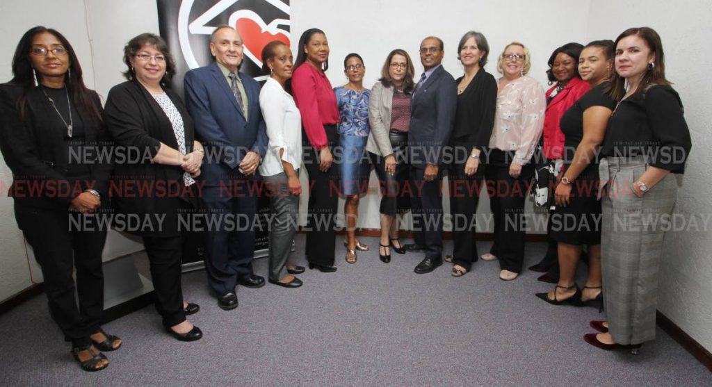 IGDS Head, Dr. Jacqueline Hosein, Scotia TT Senior Manager Leadership, Jacqueline Allamani, Criminal & Justice Committee Vice Chairman, Anthony Xavier, Rosario Williams (Massy), Kathleen Donawa-Omiss (Massy), CADV President, Roberta Clarke, Ansa McAl HR Group Director, Teresa White, Domestic Violence in The Workplace Lead, Imshah Mohammed, Massy Group SVP People & Culture, Julie Avey, TTCSI President Lara Quentrall-Thomas, Sabina Gomez (Ministry of Labour and Small Enterprises Development), Ansa Mcal Corporate Attorney at Law, La Toya Henry and Caroline Fifi (Coalition Against Domestic Violence), at the Trinidad & Tobago Chamber of Industry and Commerce, Westmoorings, where the draft policy for adoption or adaptation on Domestic Vionce In The Workplace Policy was officially launched. PHOTO: ANGELO M. MARCELLE