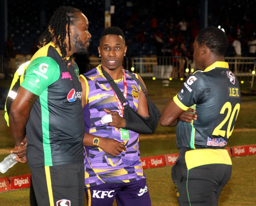 TKR's Dwayne Bravo (centre) talks to the Jamaica Tallawahs pair of Chris Gayle (left) and Jerome Taylor after Friday's match. PHOTO BY ROGER JACOB.