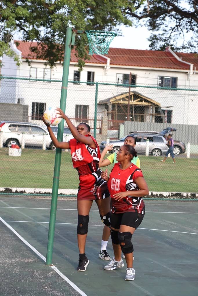  TTPOST Warriors’ Goal Keeper retrieves the ball from the goal post at the opening of the Republic Bank Laventille Netball League, last Saturday, at Nelson Mandela Park. 
