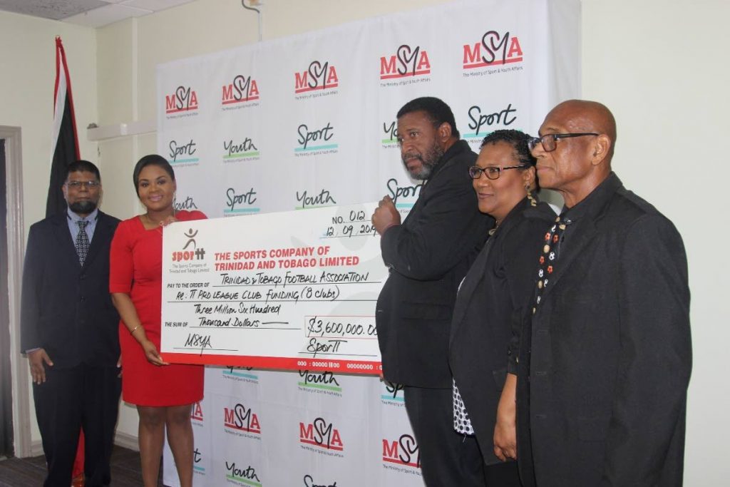 Shamfa Cudjoe, Minister of Sport and Youth Affairs, second from left, presents a cheque to David John-Williams, president of the TTFA. Looking on from left are Farook Hosein, permanent secretary, Ministry of Sport and Youth Affairs, Julia Baptiste, TTFA and Anthony Creed, Sport Company of TT.