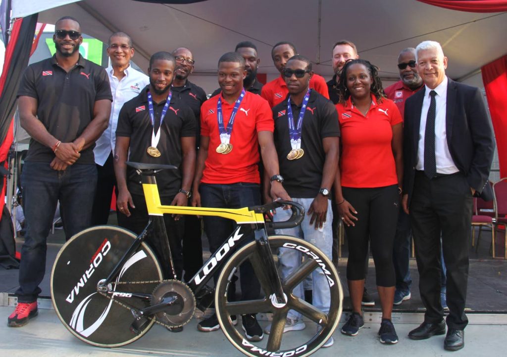 Port of Spain Mayor Joel Martinez, right, joins world record breaking cyclist Nicholas Paul, third from left front row, and the TT cycling team on the Brian Lara Promenade, on Friday. Browne is second from left front row. 