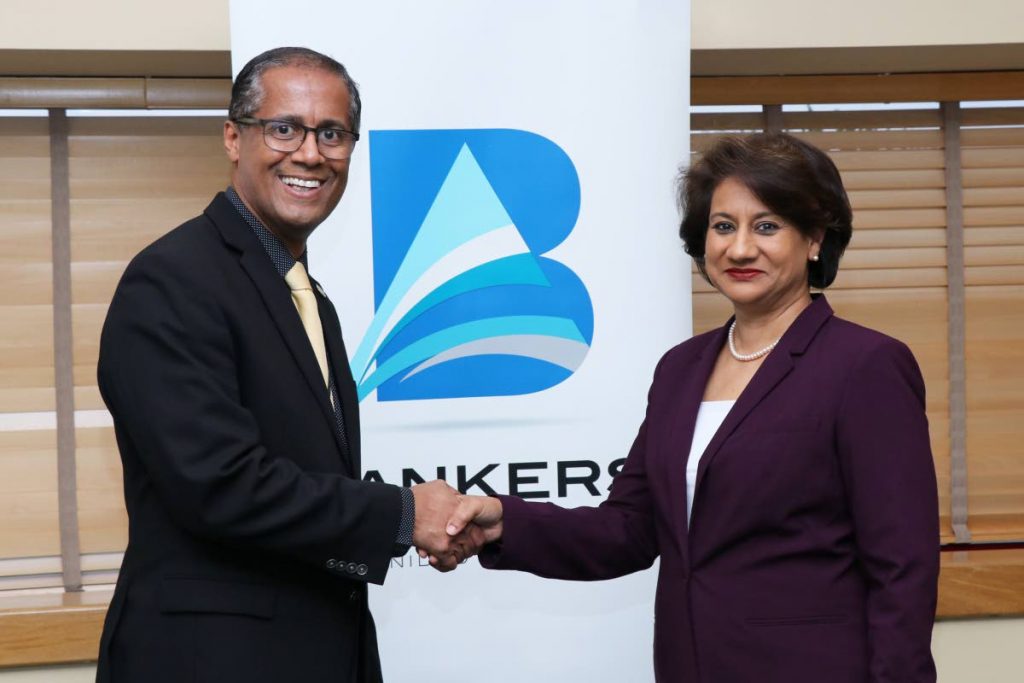 Immediate past president of the Bankers Association of TT Nigel Baptiste greets new president Karen Darbasie at the First Citizens Corporate Centre, Port of Spain, on Tuesday. PHOTO COURTESY BATT