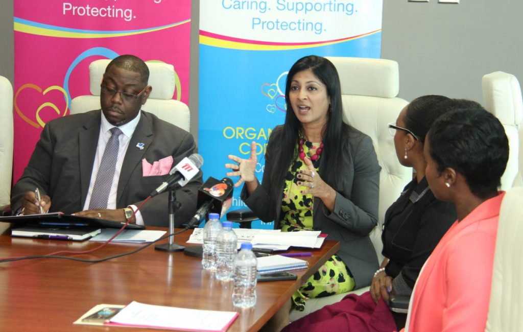 Children's Authority foster care team lead Anjuli Tewari, alongside chairman Hanif Benjamin, explains the difference between foster care and adoption during a press conference at the Ministry of the Attorney General and Legal Affairs on Friday. PHOTO BY AYANNA KINSALE 