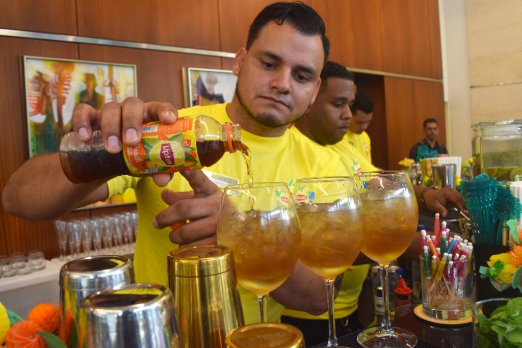 Bartender Francisco makes a cocktail using Lipton’s Iced Tea at the launch on Saturday. 