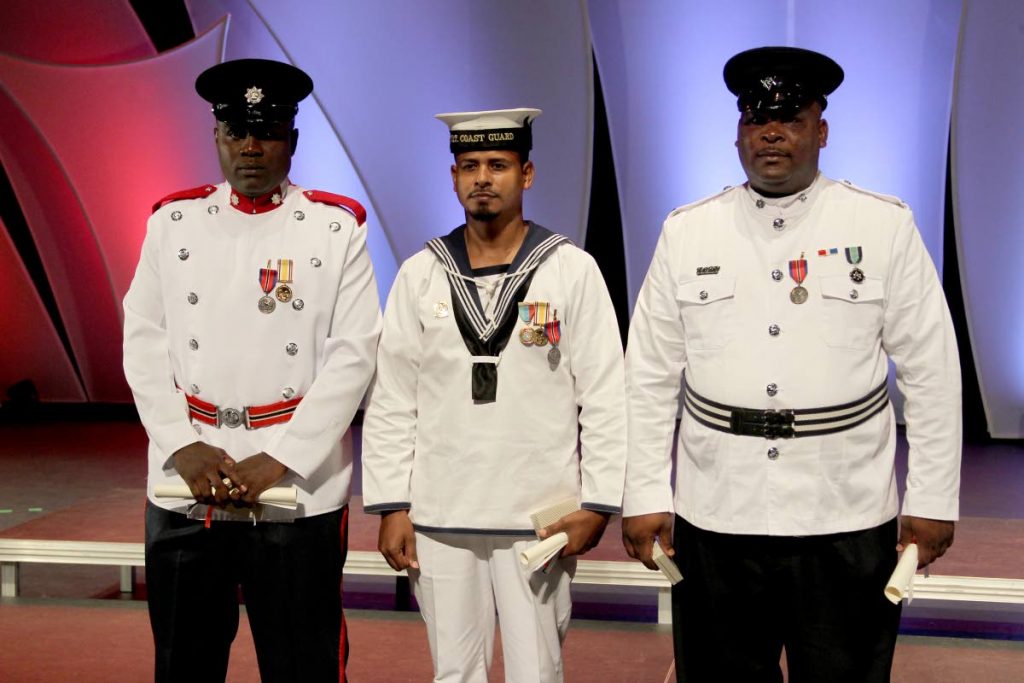 AWARDED: From left, fireman Akil Melville, Coast Guard officer Jeremy Lewis and policeman Thaddeus Caraballo on Republic Day after they received their awards for gallantry at NAPA in Port of Spain.