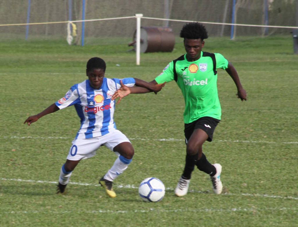 Abdul Hypolite of St Mary's, left, battles with Johnatan Clement of Malick in round five on Wednesday at St Mary's ground in St Clair. PHOTO BY ROGER JACOB.