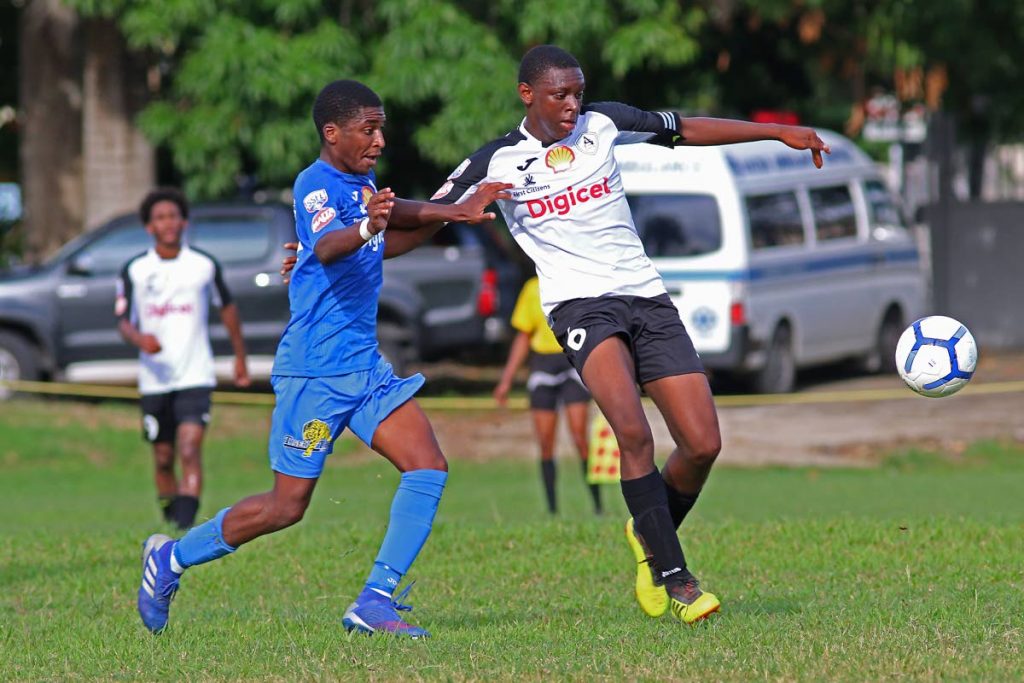 These secondary school footballers, who represent Naparima College (blue) and St Agustine (white), vie for the ball in their SSFL match,at Lewis St, San Fernando,yesterday.