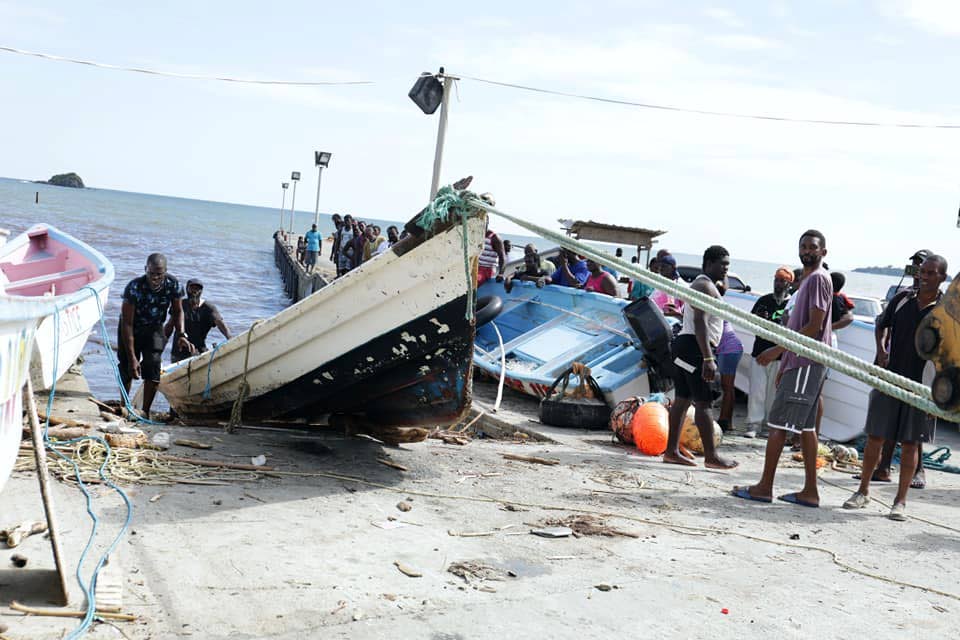 Roxborough fishermen salvage a boat which sank during the passage of Tropical Storm Karen. PHOTO COURTESY OFFICE OF CHIEF SECRETARY
