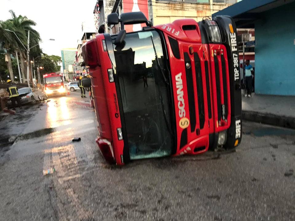 A fire tender lies on its side after a collision along Independence Square, early this morning.   PHOTO COURTESY SOCIAL MEDIA