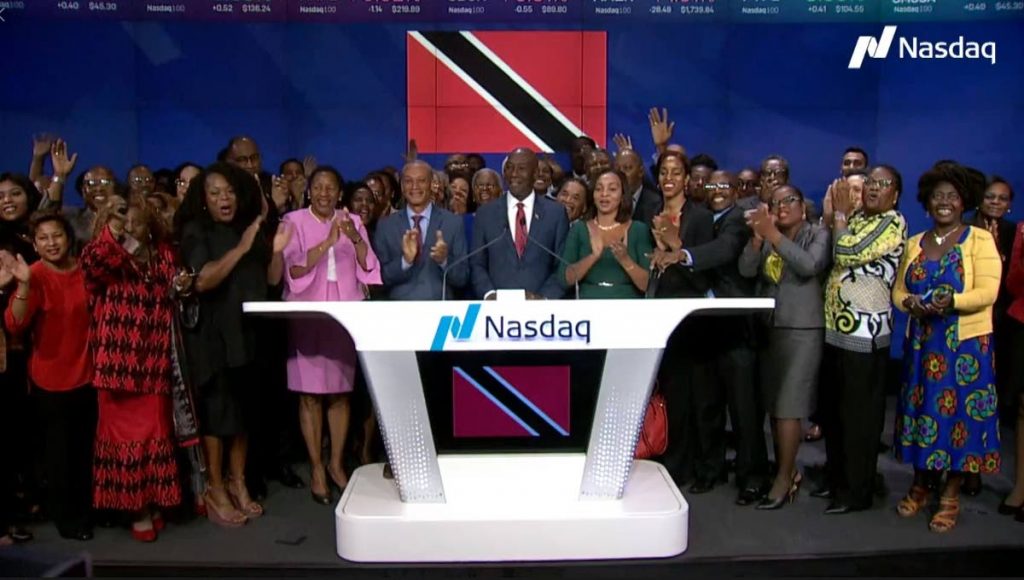 TRINI CHEER: Prime Minister Dr Rowley is surrounded by cheering people after he rang the bell to start the day's trading at the New York Stock Exchange on Friday. 