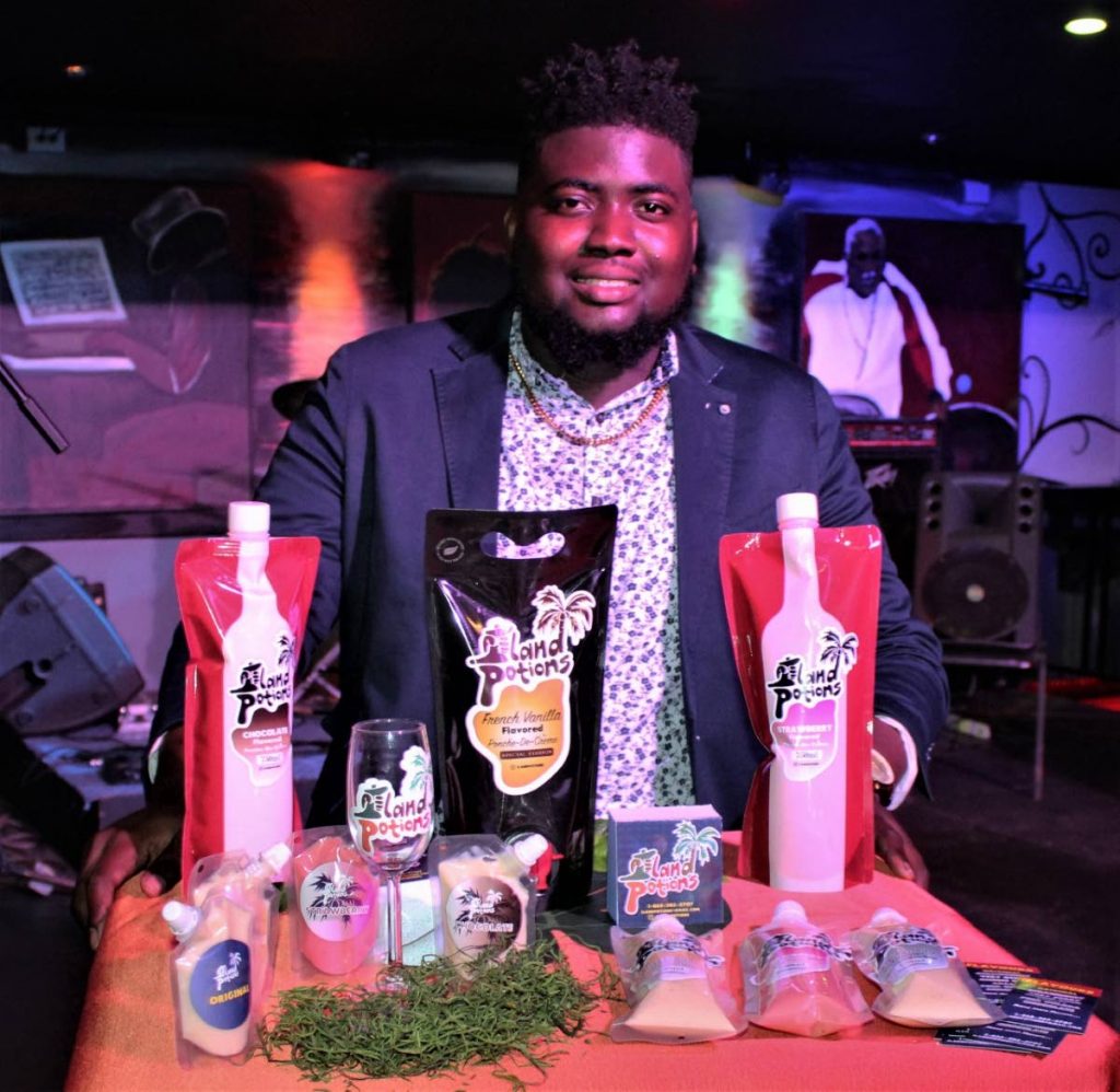 Terrell Daniel stands behind his Island Potions products at the launch at Kaiso Blues Cafe, Wrightson Road, Port of Spain.
