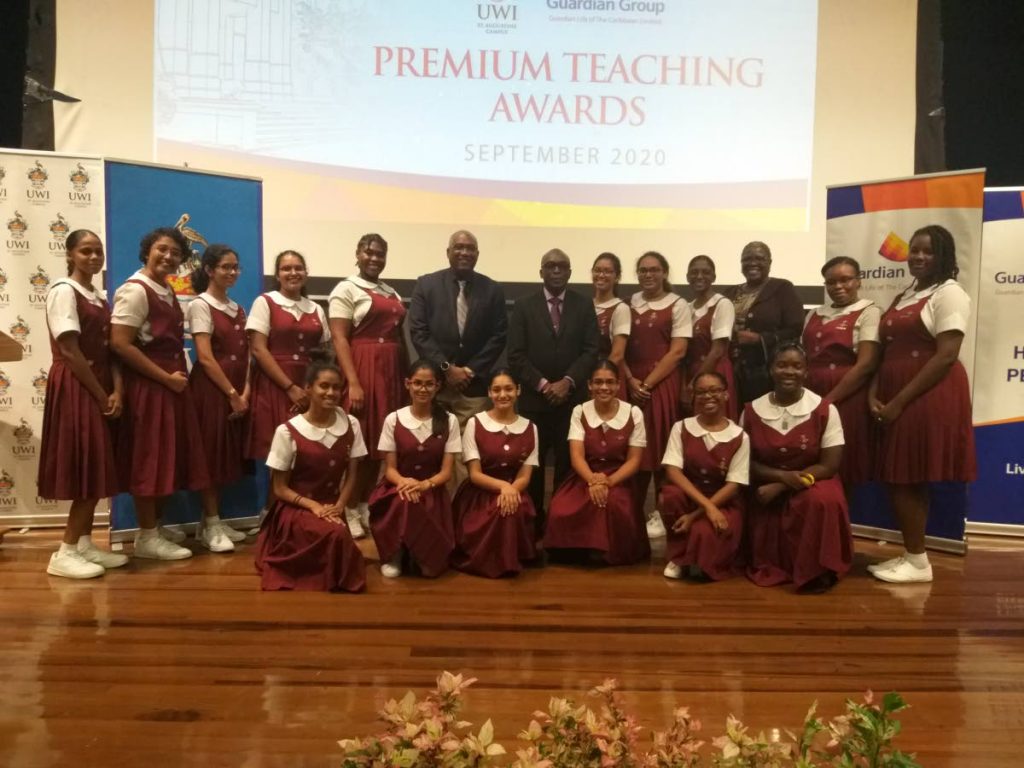 UWI principal Professor Brian Copeland and Professor Wendel Abel (L-R centre, back row) pose with students of Holy Faith Convent Couva at a public lecture on tackling mental health issues in the education system, UWI, St Augustine on Friday. PHOTO BY TYRELL GITTENS.  