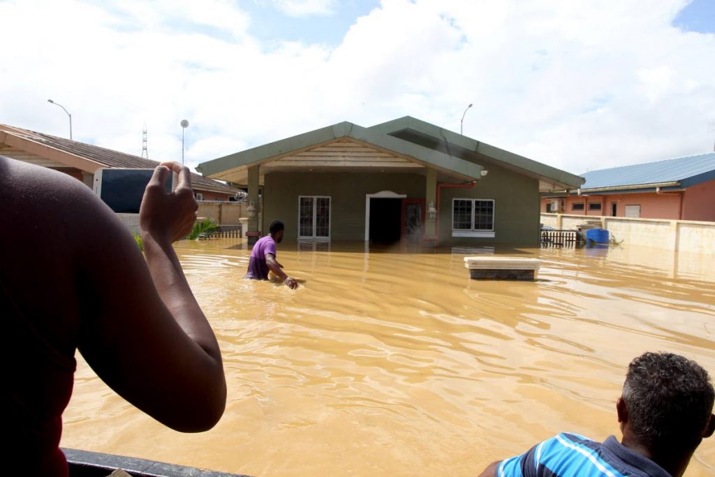 FLASHBACK: Rescuers check flooded houses in the HDC Greenvale, La Horquetta housing deevelopment which was severely impacted by flooding in October last year. 