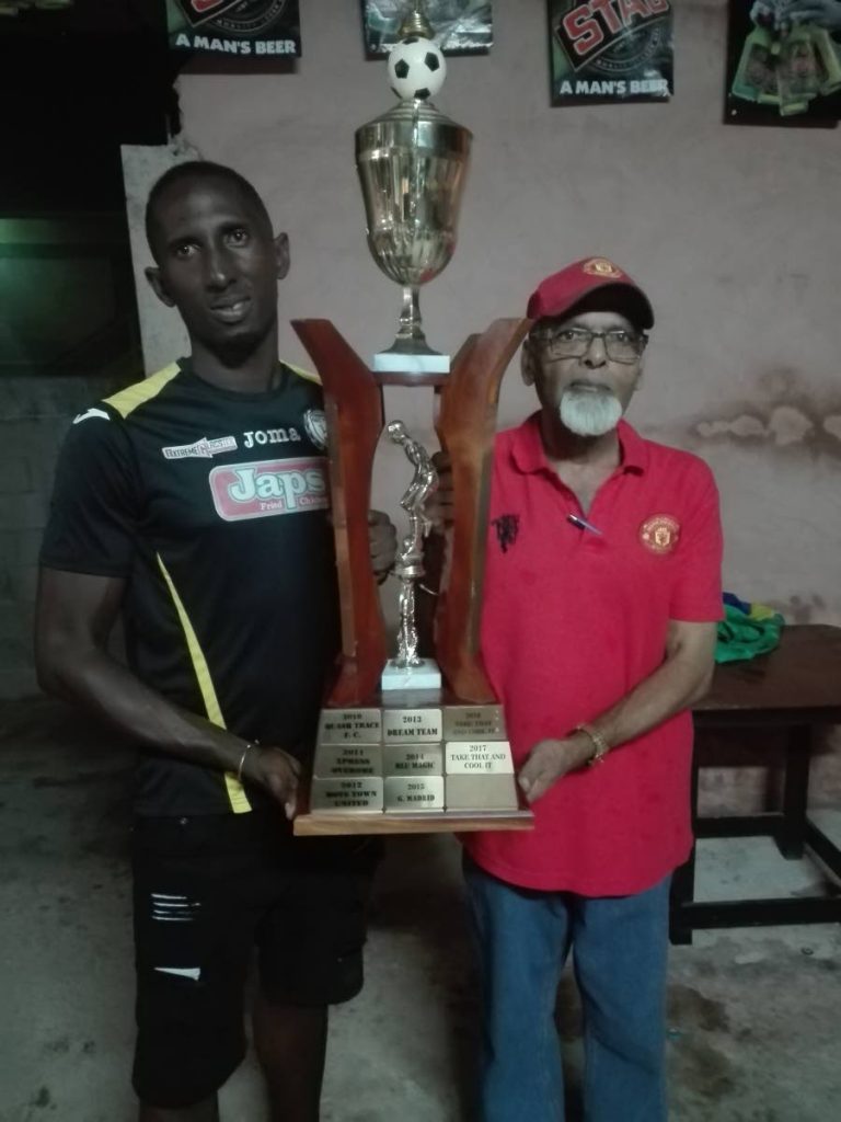 Gremio player/manager Ashky Charles, left, 2018 winner of the  Fishing Pond Football League, alongside organiser Prakash Ramkissoon. - 