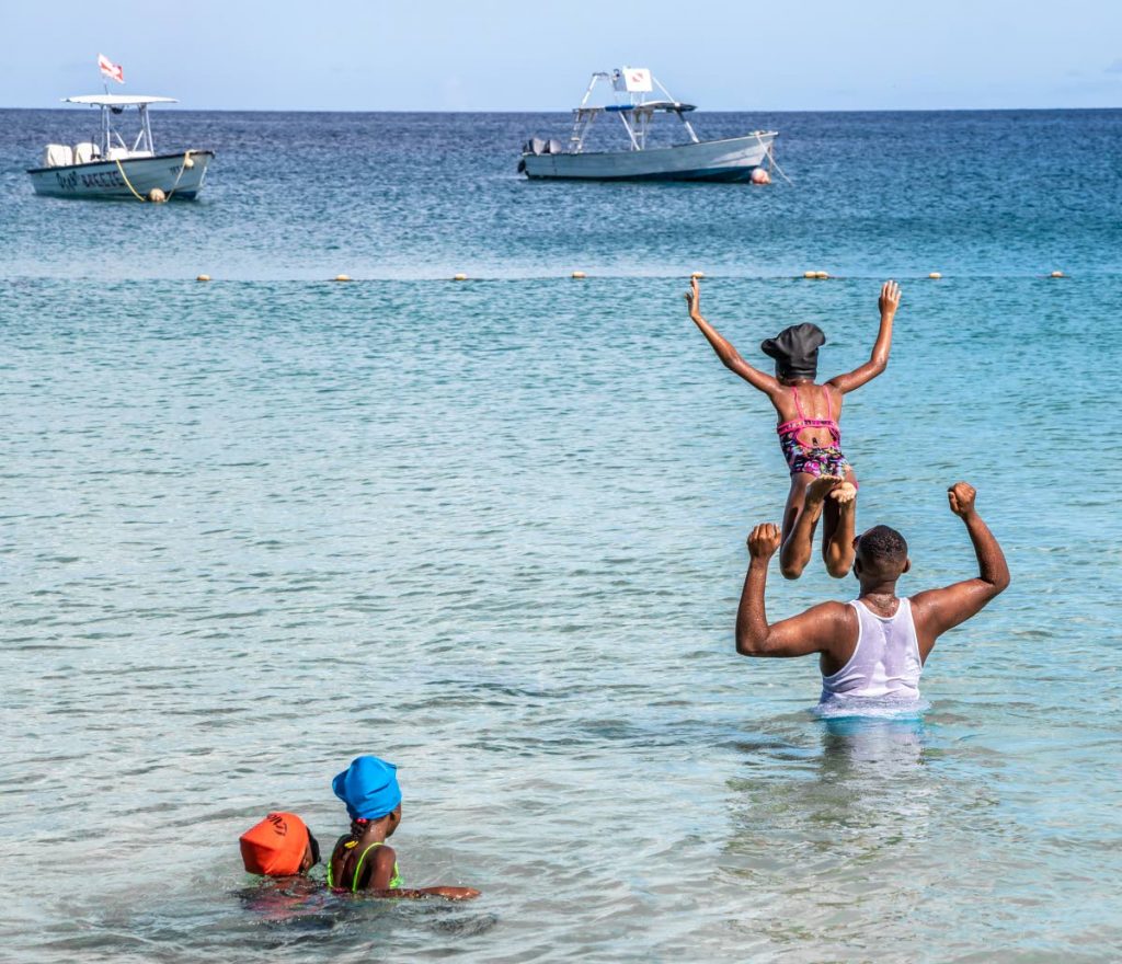 A family enjoys a day at Store Bay, Tobago. The TT Met Service has issued a week-long advisory for rough seas from Sunday until next Saturday. FILE PHOTO - 