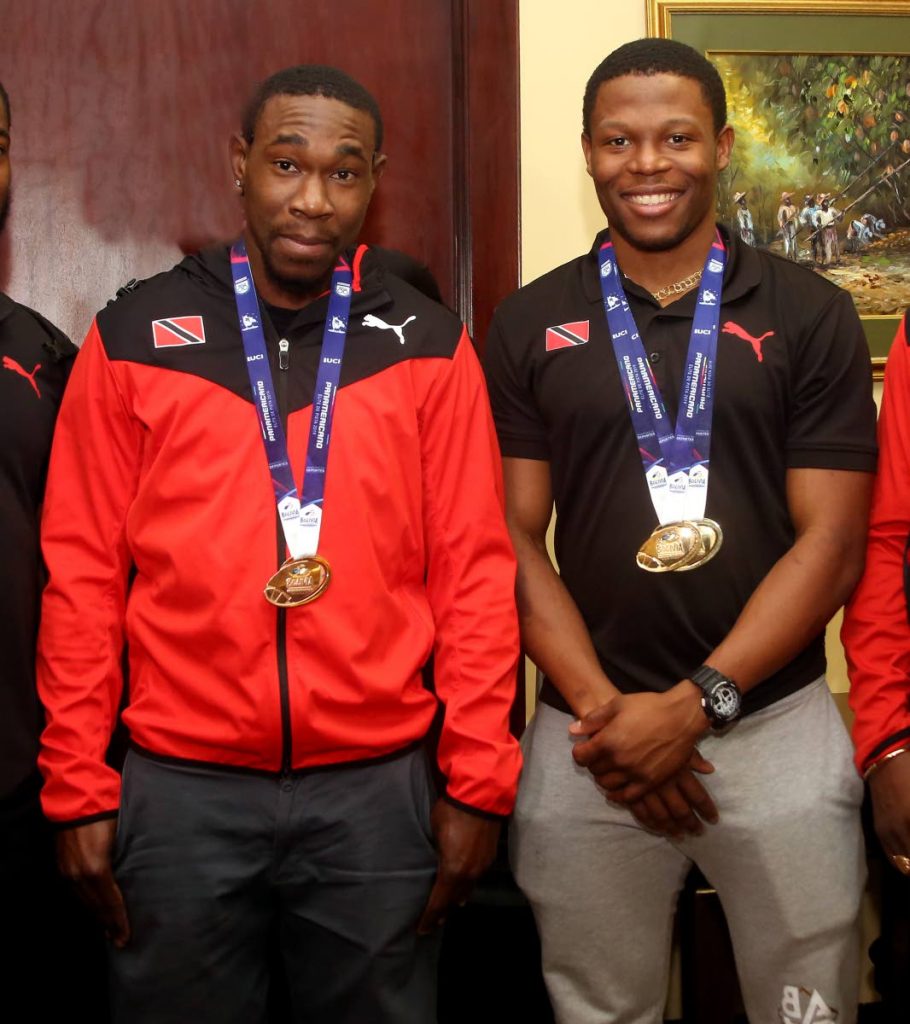 TT’s Nicholas Paul,right, and Keron Bramble display their medals on their return to TT after a successful Pan Am Track Cycling Championships, held in Lima,Peru recently. 