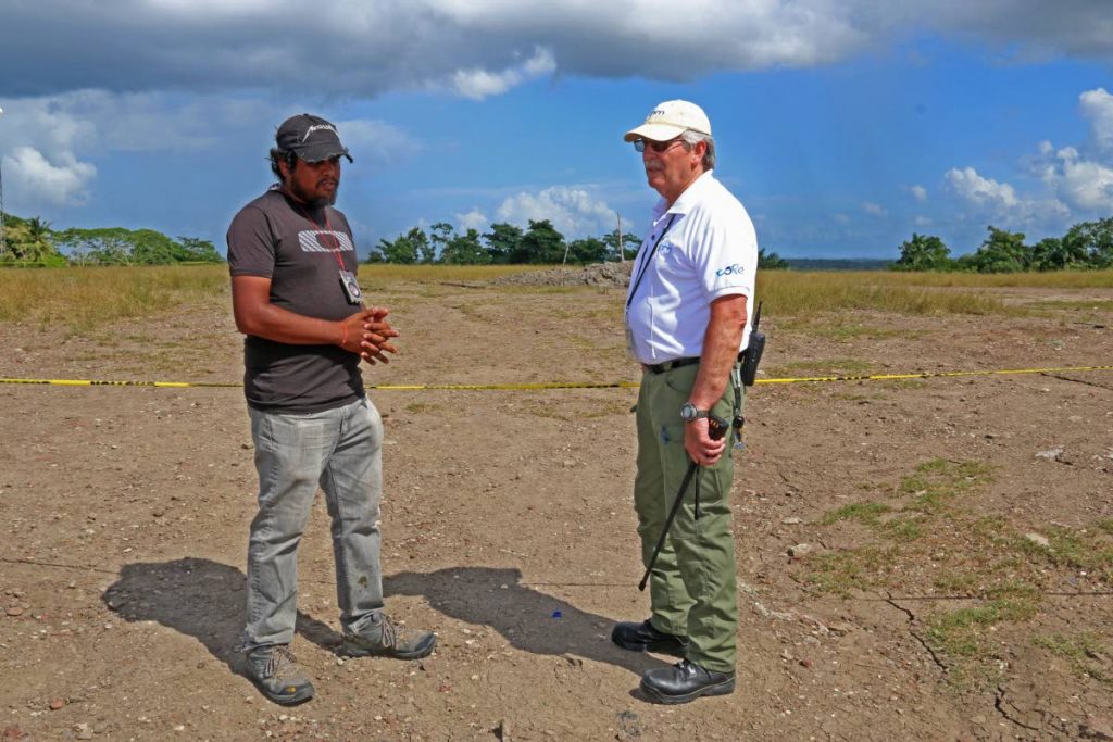 ON SITE: Geologist Xavier Moonan, left, and ODPM regional coordinator Eric Mackie at the mud volcano in Piparo on Sunday. PHOTO BY MARVIN HAMILTON
