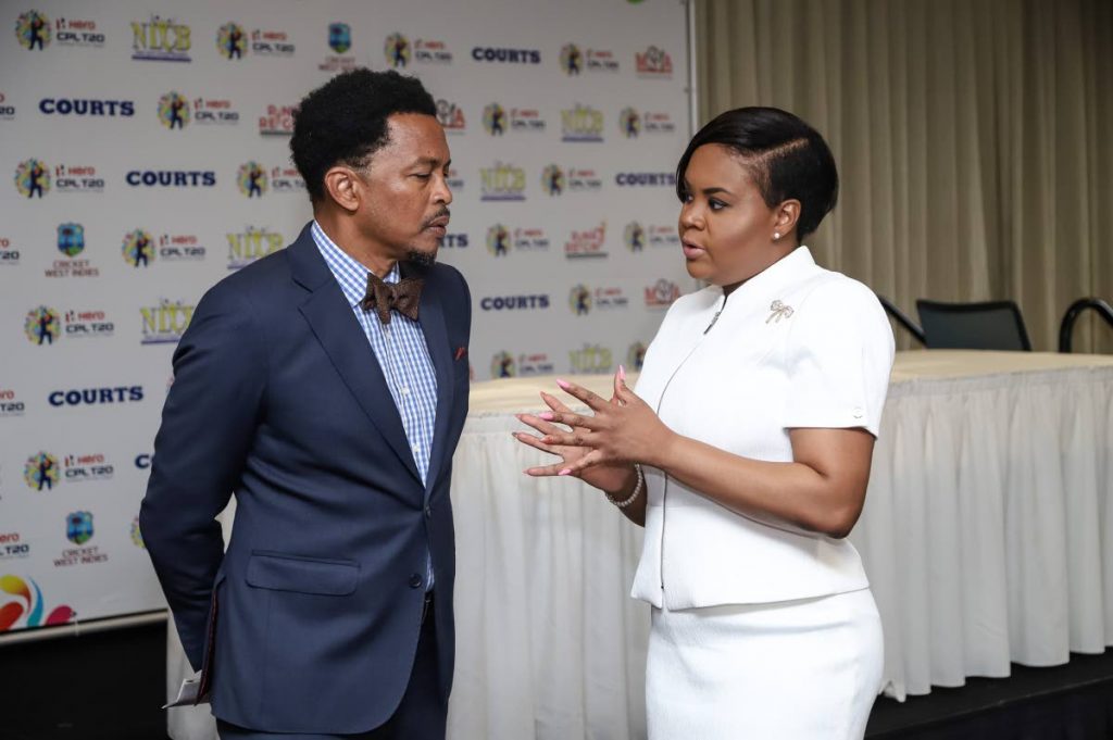 Minister of Sport and Youth Affairs Shamfa Cudjoe,right, speaks with president of the TT Olympic Committee, yesterday, at a press conference hosted by the Hero Caribbean Premier League,at Hilton Trinidad,St Ann’s.