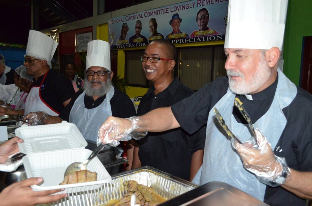 Fr Derek Anton of the Chaguanas parish proudly serves his gravy pork chops.