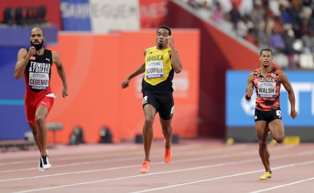 Akeem Bloomfield, of Jamaica, center, Machel Cedenio, of Trinidad And Tobago, left, and Julian Jrummi Walsh, of Japan, right, race in a men's 400 meter semifinal at the World Athletics Championships in Doha, Qatar, Wednesday, Oct. 2, 2019. (AP Photo/Petr David Josek)