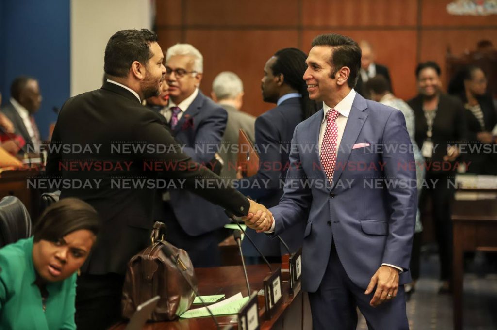 Tourism Minister and Attorney General Randall Mitchell greet each other at the opening of Parliament on October 2. PHOTO BY JEFF K MAYERS