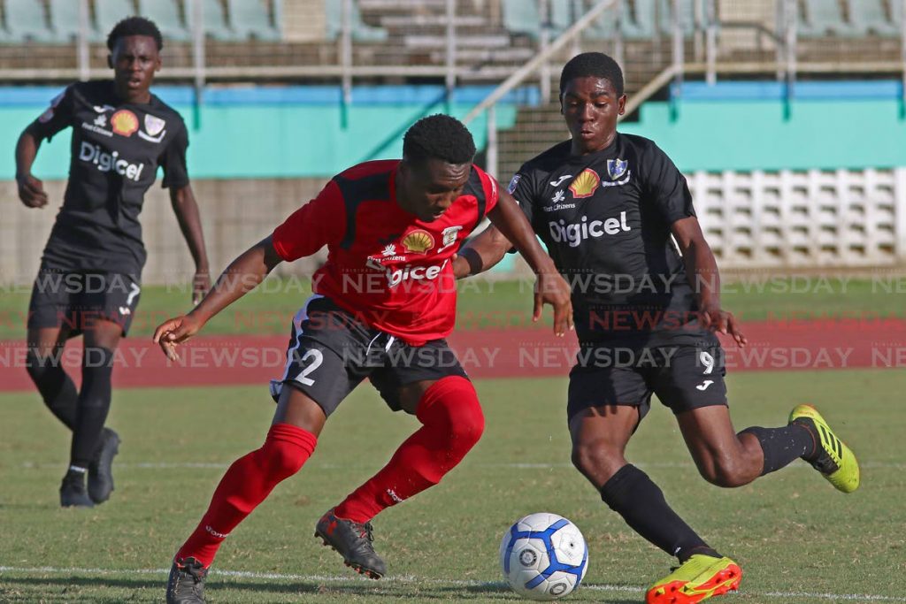 St Benedict's Nkosi Rosales,right, vies for the ball with St Anthony's Timoth Brandel,during action in the SSFL encounter, at the Manny Ramjohn Stadium,Marabella,yesterday. Photo by Marvin Hamilton