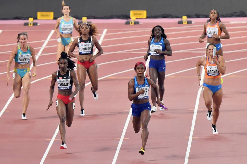 Kazakhstan's Olga Safranova, Trinidad and Tobago's Kamaria Durant, United States' Kiara Parker and Netherlands' Naomi Sedney, from left, compete in the women's 4x100 metre relay at the World Athletics Championships in Doha, Qatar, today. (AP Photo)