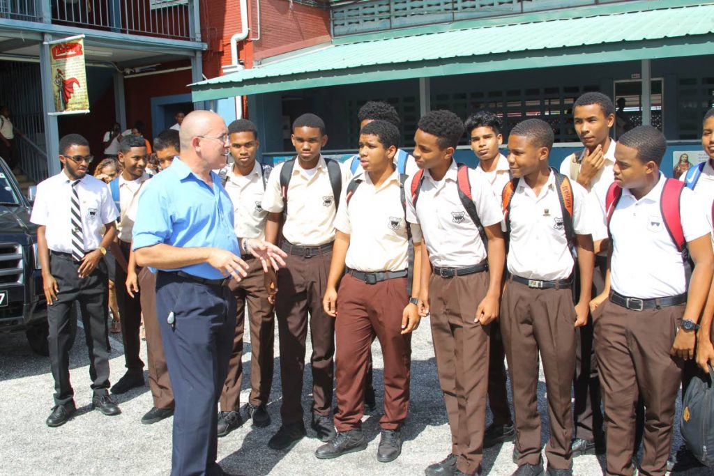 LISTEN UP: Holy Cross College principal Gary Ribeiro has a brief chat with a group of his students last week.  PHOTO BY ROGER JACOB