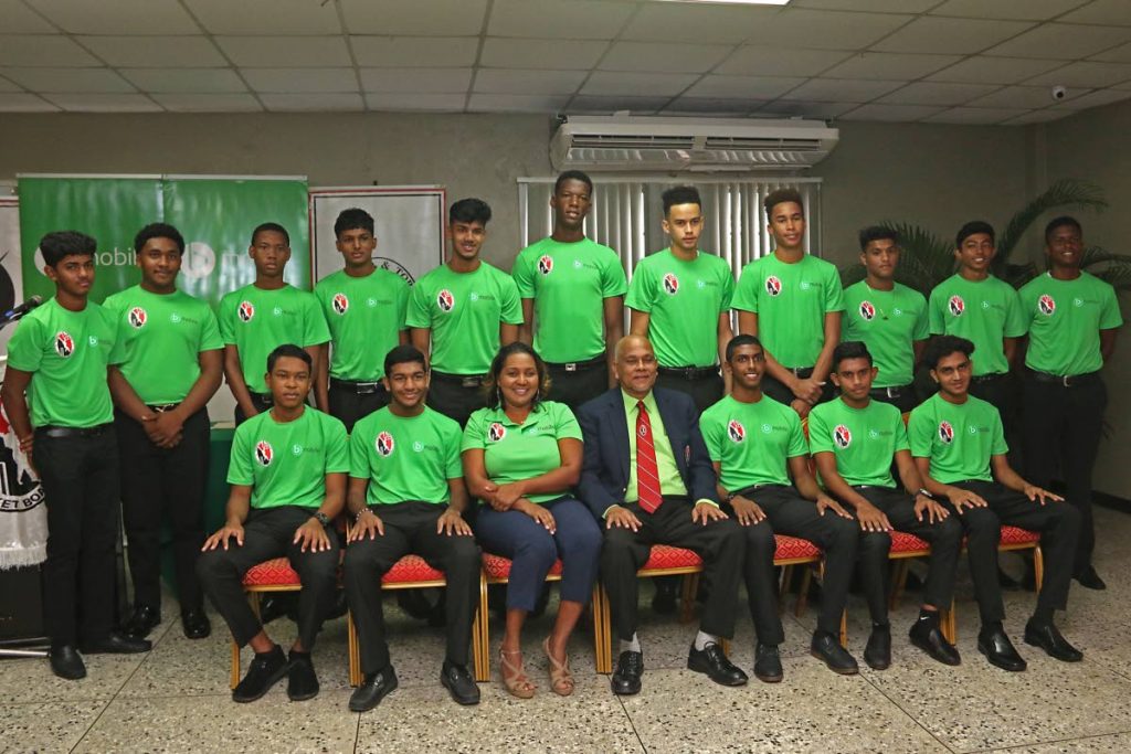 TSTT manager, corporate responsibility and community relations coporate communications, Anjanie Ramesar-Soom (seated third from left) and TT Cricket Board president Azim Bassarath(seated at centre)take a group with the bmbile/TTCB Youth Academy inductees at the National Cricket Centre,Balmain, Couva, yesterday.