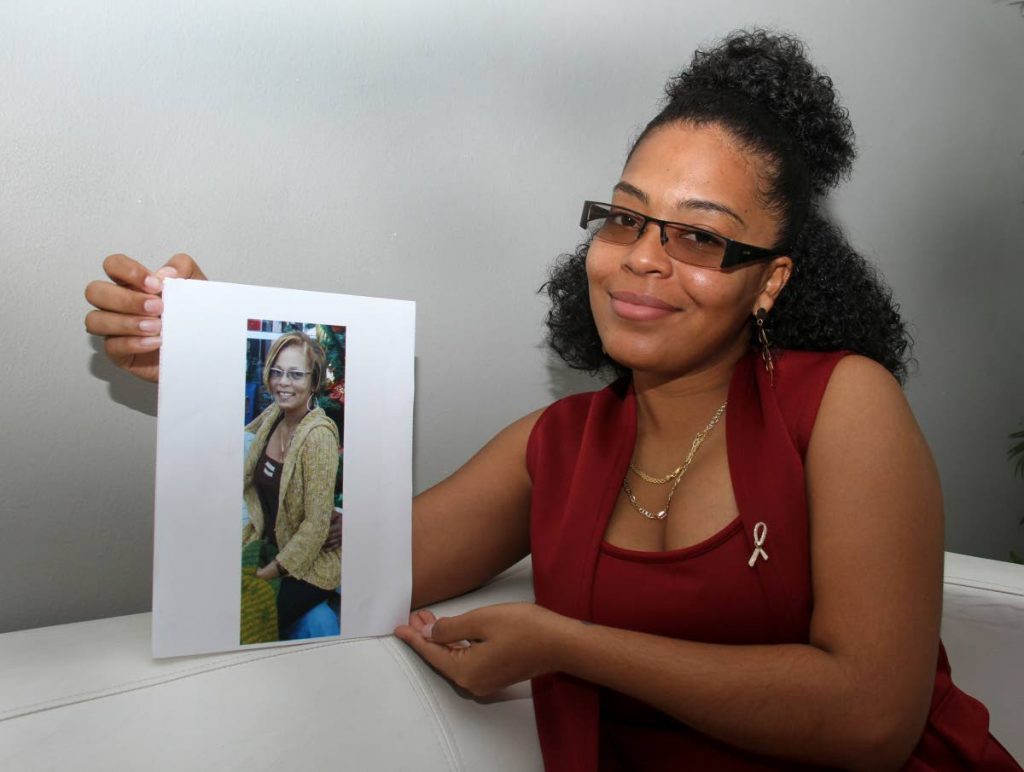 Khadine Williams displays a photo of her late mother who lost the fight against cancer - Ayanna Kinsale
