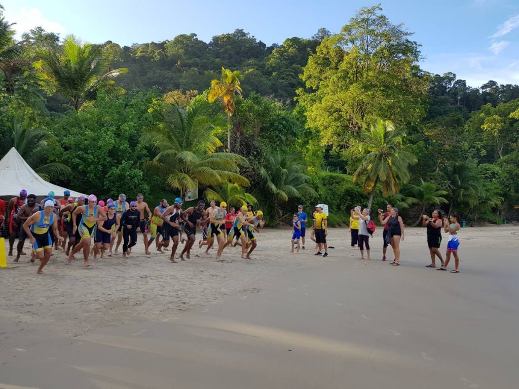 Athletes take part in the inaugural Aquabike competition which ran and swam off at the Las Cuevas Beach Facility, recently. - 