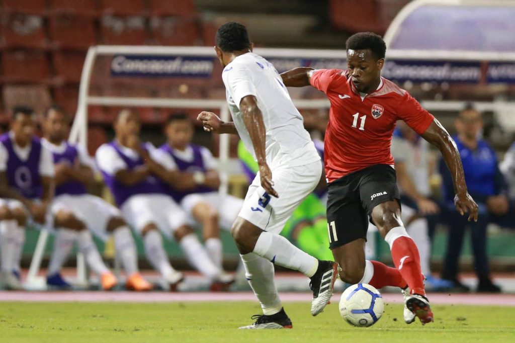 Trinidad and Tobago's Levi Garcia takes on a Honduras player in a Concacaf Nations League game at the Hasely Crawford Stadium, Mucurapo, on Thursday. PHOTO BY ALLAN V CRANE/CA-images