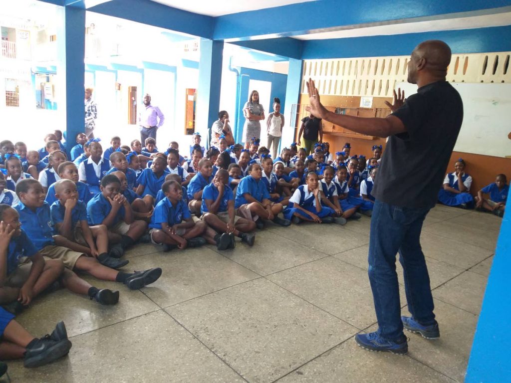 Comedian Errol Fabien tells a story to students of the Morvant Epiphany Anglican School during the launch of the Act of Random Kindess Project.