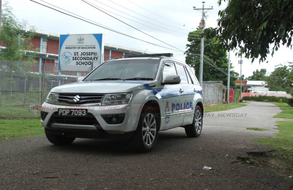 Police officers on patrol at the St. Joseph Secondary School on Monday. - Ayanna Kinsale