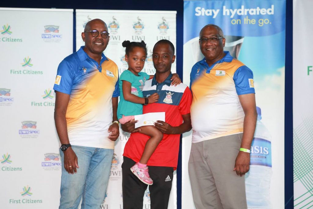 TT’s first male athlete of the UWI Spec Half-Marathon Matthew Hagley (C) is flanked by Kurt Headley, head Retail Banking Unit, First Citizens (left) and Professor Brian Copeland, during the event, which was held on October 16. - Allan V. Crane