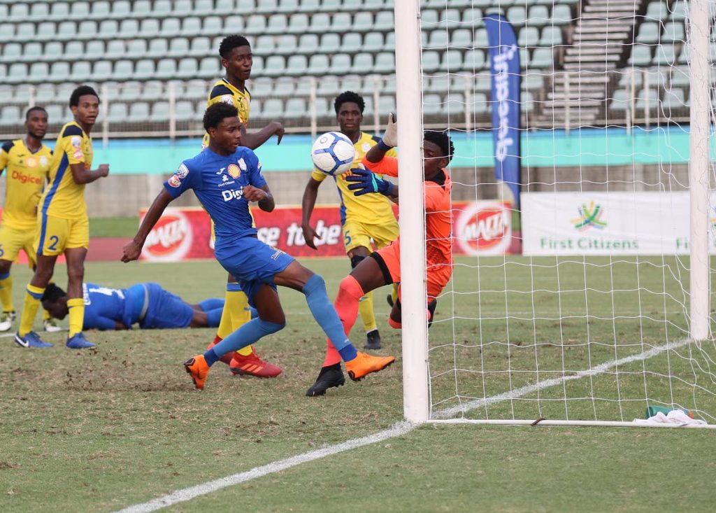 Presentation College San Fernando’s goalie Isaiah Williams denies an attempt on goal by Naparima College’s Seon Shippley during the Secondary Schools Football League match, at the Manny Ramjohn Stadium, Marabella. - Lincoln Holder