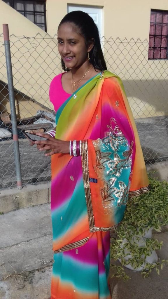 Dressed to impress: Rahvisha flashes a smile in her cultural wear as she heads off to a school cultural event.  - 