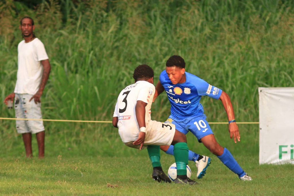 San Juan North's Emmanuel Thomas (#3) challenges Naparima's Decklan Marcelle for the ball during yesterday's match. PHOTO BY MARVIN HAMILTON. - MARVIN HAMILTON