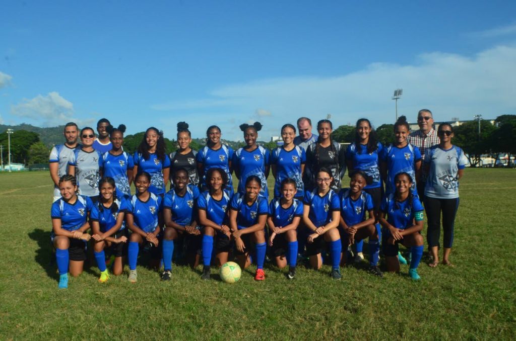 (Back row from left to right) Officials of the Holy Name Convent football team Mark De Souza; Donna Nicholas, Damien Frederick, head coach Gordon Perkins, Gregory De Souza, and manager Alana Ramdeen are all smiles alongside members of the Holy Name Convent football team which last week won the North Zone U15 and U20 titles. - Photo courtesy RONALD DANIEL