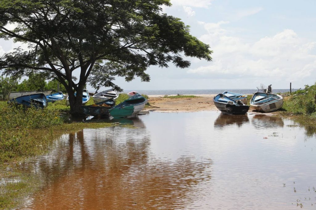 Fishing boats in Icacos are brought inland as rough seas continue to batter the coastlines of Trinidad and Tobago.  PHOTO BY LINCOLN HOLDER. - 