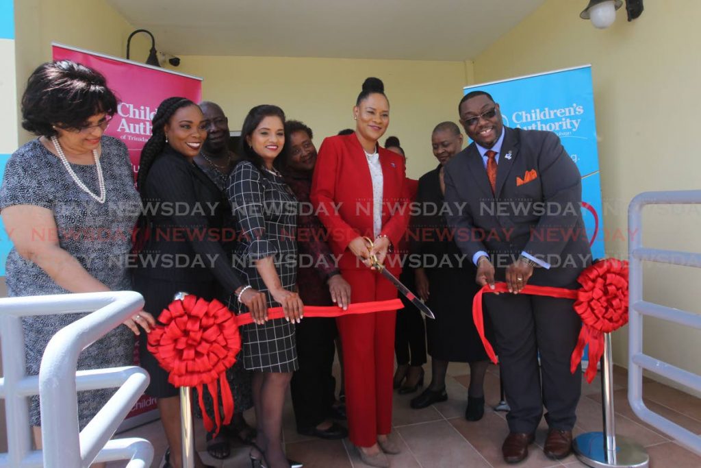 Ayanna Webster-Roy, minister of state, Office of the Prime Minister, gender and child affairs cut the ribbon with Hanif E.A Benjamin, chairman of the board of management  of the Children's Authority of Trinidad and Tobago at the opening of the Chaguanas regional office of the Children's Authority office along Chaguanas main road.

Photo: Lincoln Holder    