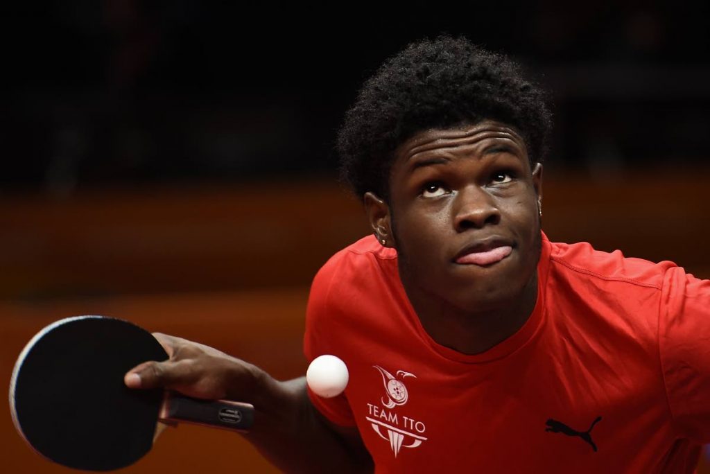 TT's Aaron Wilson serves against Vanuatu's Yoshua Shing during their men's singles table tennis game at the 2018 Gold Coast Commonwealth Games at the Oxenford Studios venue in Gold Coast . Wilson won 15-3,11-6,8-11,11-7 and 13-11.  (AFP PHOTO) - YE AUNG THU