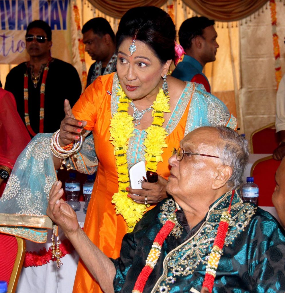 In this May 29, 2017 file photo Opposition Leader Kamla Persad-Bissessar and Maha Sabha secretary general Satnarayan Maharaj chat at Indian Arrival Day celebrations at Parvati Girls' HIndu College, Debe. - 