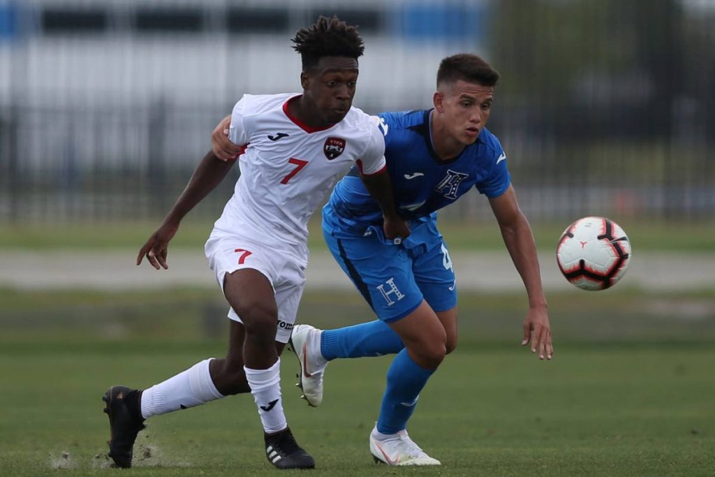 Jaiye Sheppard (left) in action for TT Under-17 team during a match against Honduras in the 2019 Concacaf World Cup Qualification tournament.  - 
