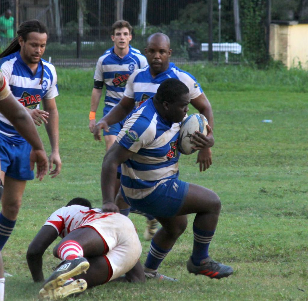 Wendell Fullerton of Trinidad Northern makes a run after avoiding a tackle from a Carib RFC player during last Saturday’s Bruno Browne Cup game at the President’s Ground, St Ann’s.  - ROGER JACOB