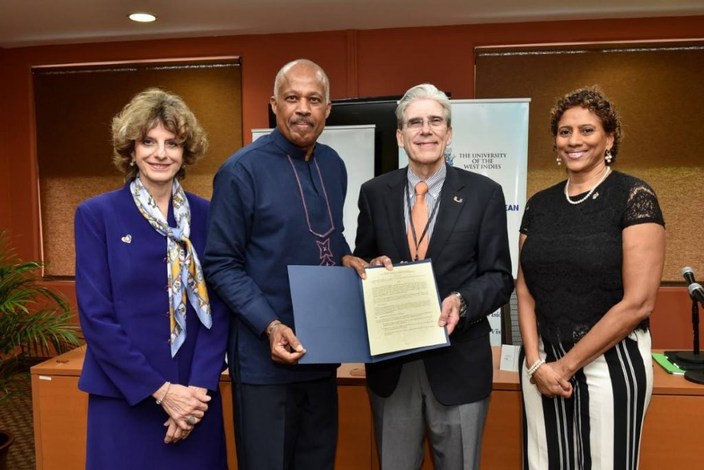 Vice-Chancellor of The UWI, Professor Sir Hilary Beckles, second from  left, and president of UM  Dr Julio Frenk, second right, show off the signed MOU at a meeting of the two universities at The UWI’s Regional Headquarters in Jamaica on October 22. Sharing the moment are UM’s vice resident for hemispheric and global affairs, Dr Maria de Lourdes Dieck-Assad left, and Director of The UWI Latin American-Caribbean Centre, Ambassador Gillian Bristol, right. - 